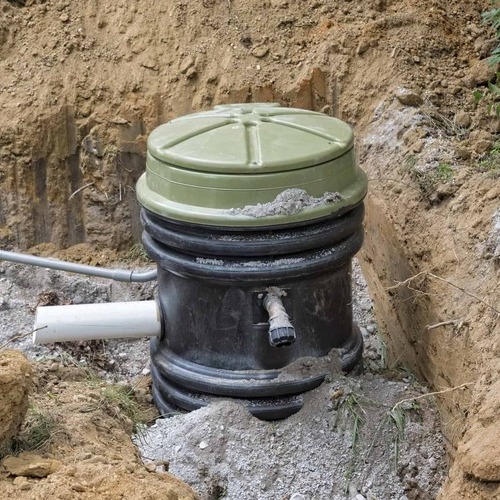 grinder pump sitting in the ground